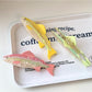 Beau hair claw clip in fish shape displayed on a white background