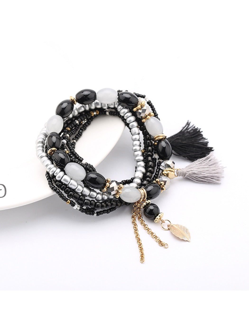 Lovra bracelet laid flat showing full length of beaded strands and tassel pendant