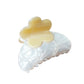 Beau hair clip held in hand showing size and colorful flower design