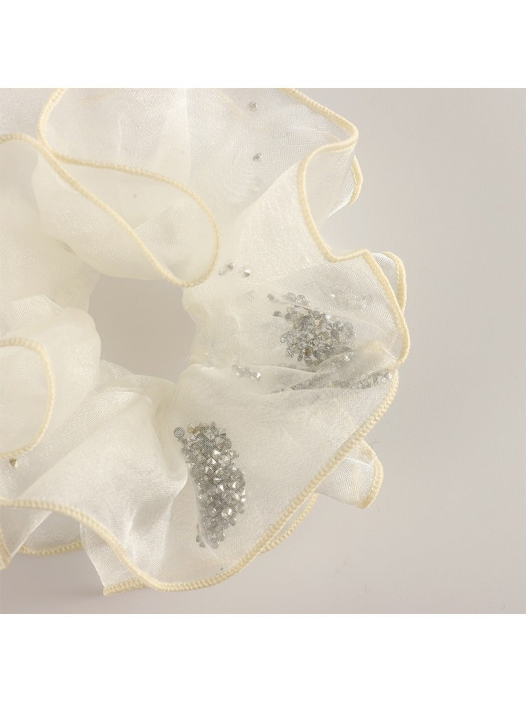 Side view of Gifty minimalist scrunchie highlighting the layered ruffles in pastel color