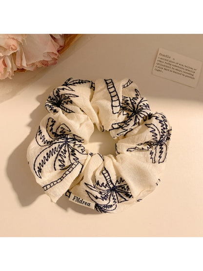 Vintage coconut tree print scrunchie displayed on white background