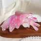 Butterfly hair claw clip resting on a white surface