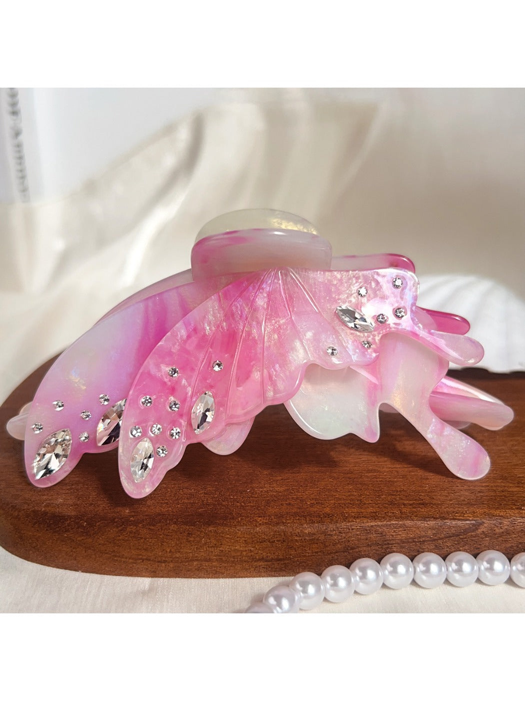 Butterfly hair claw clip resting on a white surface