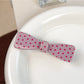 Beau sweet pink hair claw clip with white polka dots against a pastel background