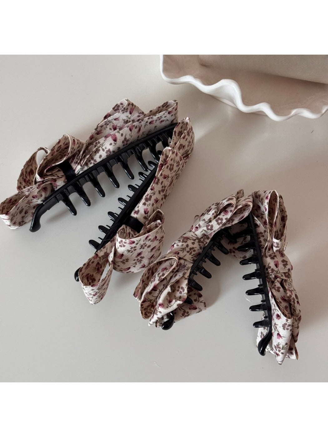 Close-up of Beau floral print bow hair clip showing fabric texture and pattern