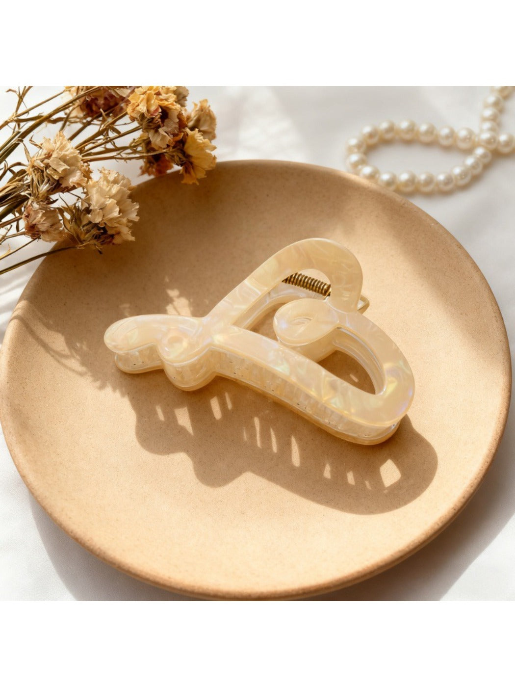 Beau heart shape hair claw holding a ponytail, close-up