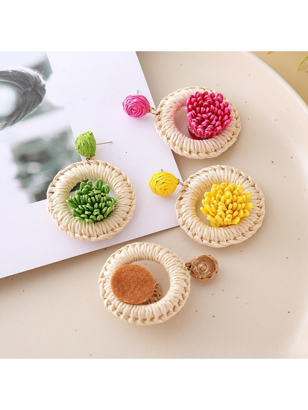 Earedge raffia woven earrings displayed on a white background showing detailed craftsmanship