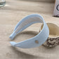 Gifty wide solid color headband worn during outdoor activity