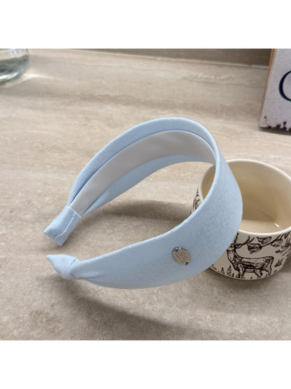 Gifty wide solid color headband worn during outdoor activity