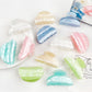 Beau macaron colored crescent shaped claw clip on white background