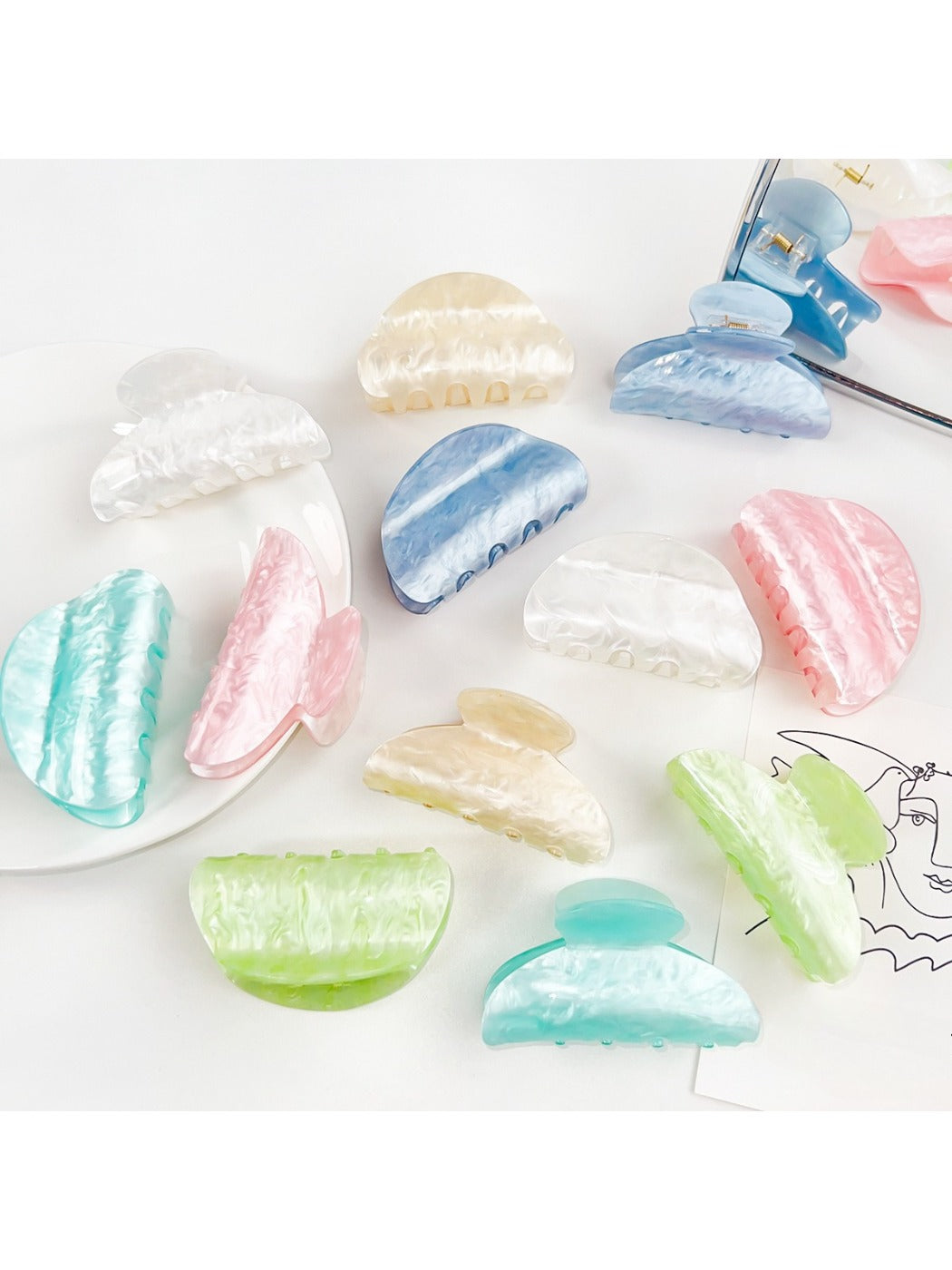 Beau macaron colored crescent shaped claw clip on white background
