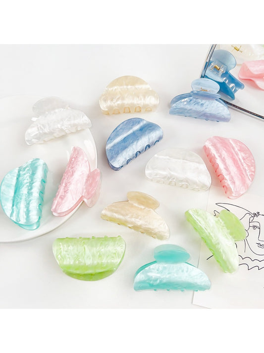 Beau macaron colored crescent shaped claw clip on white background