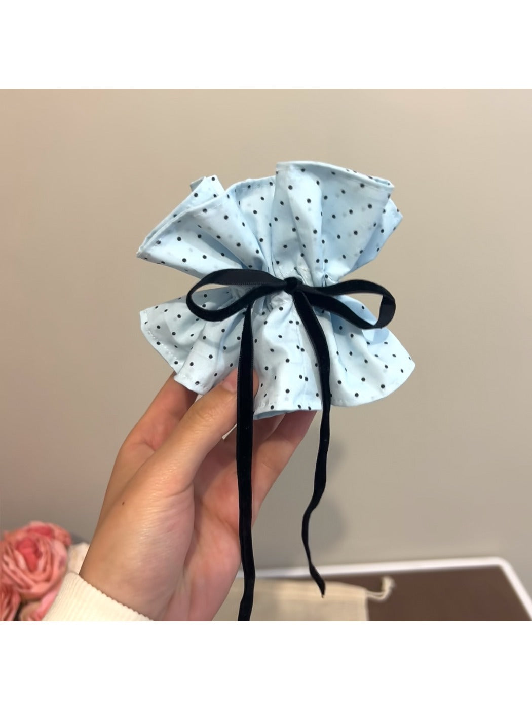 Gifty polka dot bow scrunchie paired with casual outfit accessories on a flat lay