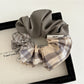 Top view of Gifty scrunchie showing detailed patchwork and plaid fabric sections