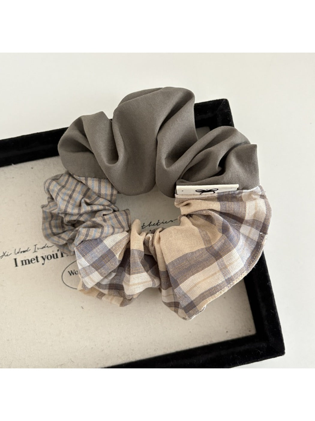 Top view of Gifty scrunchie showing detailed patchwork and plaid fabric sections