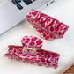 Beau pink leopard print half round claw clip holding hair in place