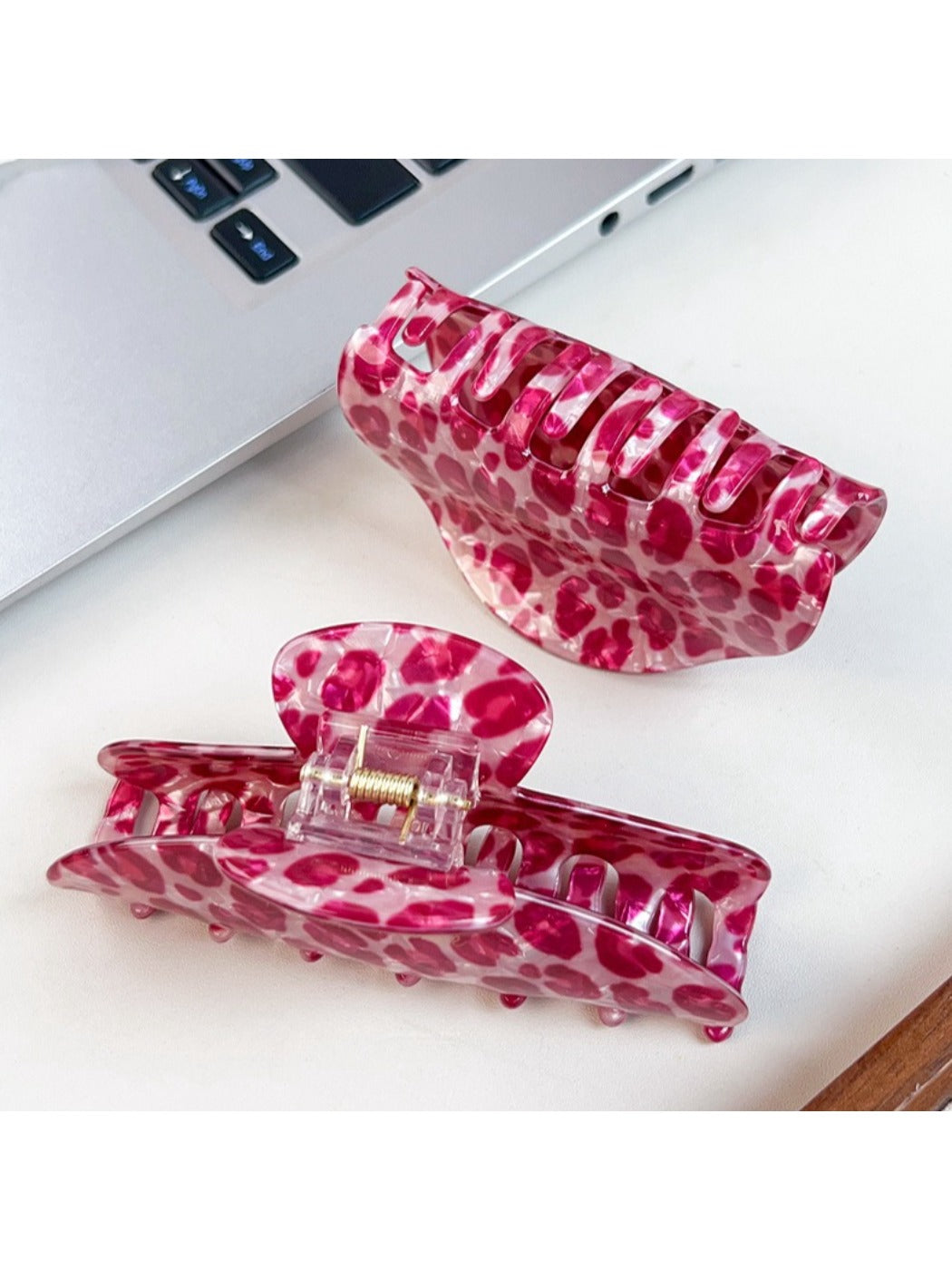 Beau pink leopard print half round claw clip holding hair in place