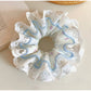 Side view of Gifty double layer tiny floral lace scrunchie highlighting lace details