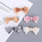Beau hair clip with a large sweet bow in soft pink fabric