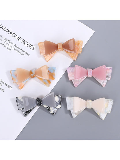 Beau hair clip with a large sweet bow in soft pink fabric
