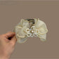 Close-up of Beau hair claw clip showing bow design and clasp mechanism