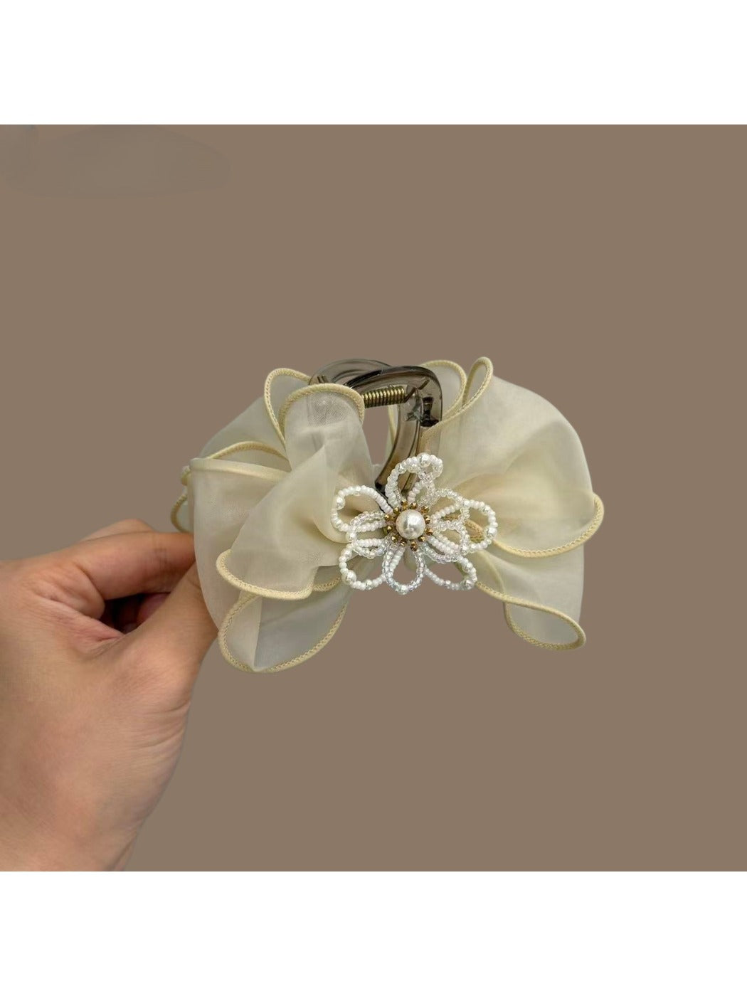 Close-up of Beau hair claw clip showing bow design and clasp mechanism