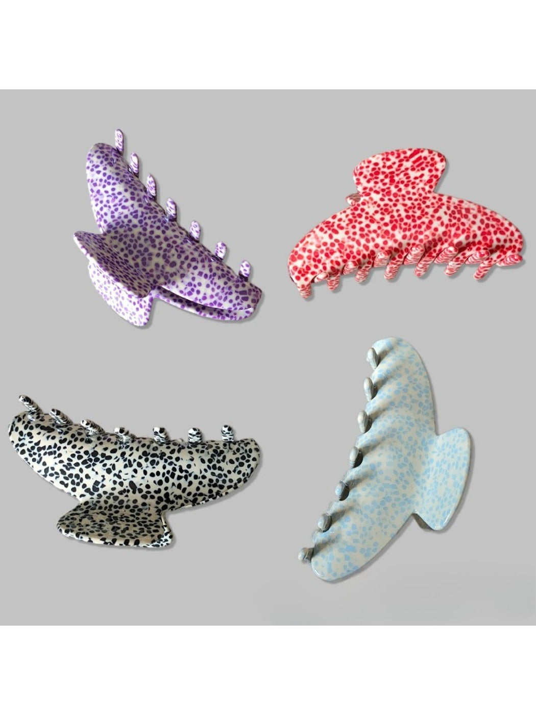 Beau claw clip held in hand displaying size and polka dot pattern