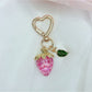 Keypus strawberry charm keychain with vibrant red color and green leaves detail