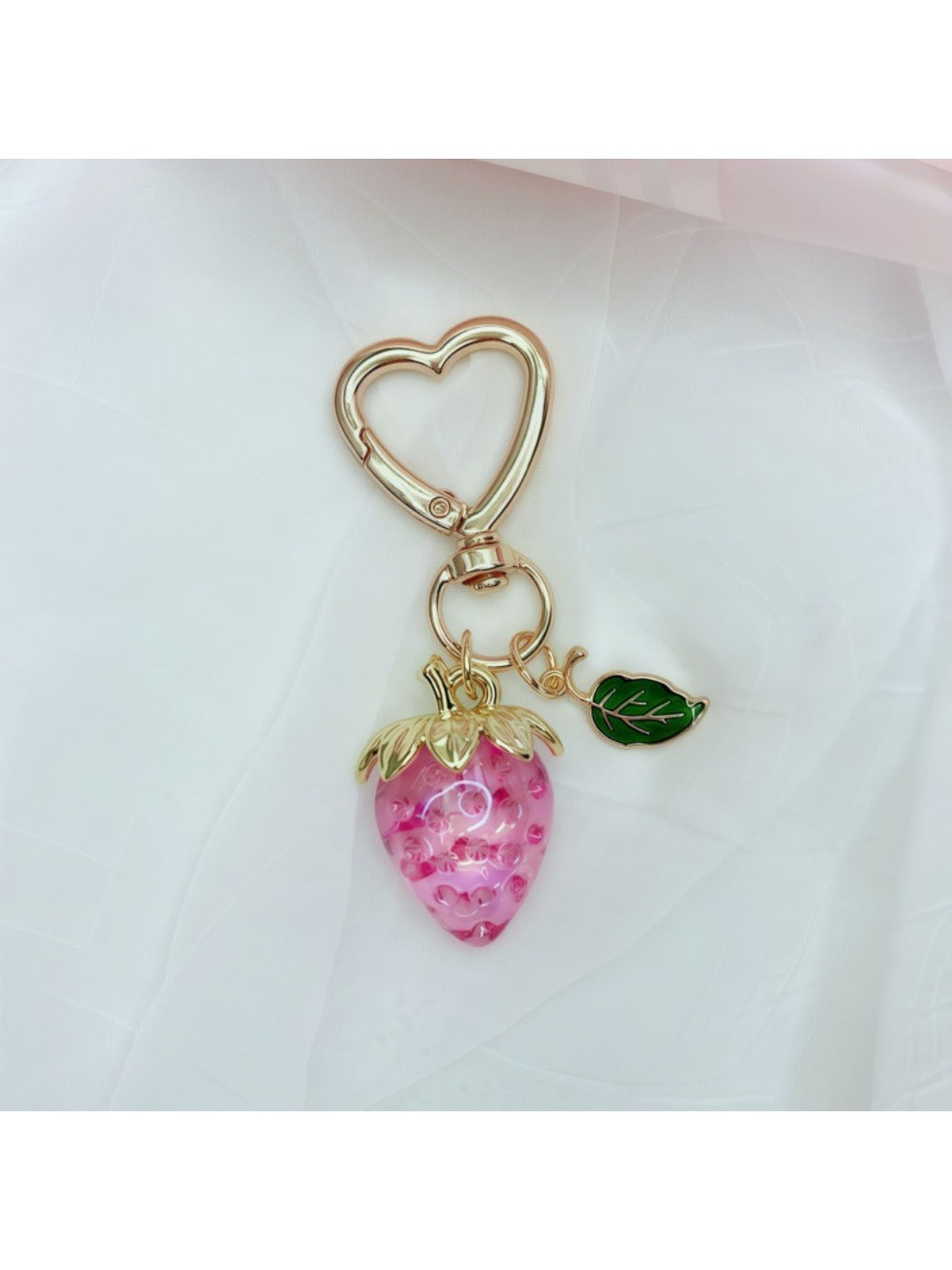 Keypus strawberry charm keychain with vibrant red color and green leaves detail