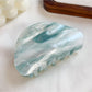 Beau hair claw clip displayed with soft lighting emphasizing translucent material