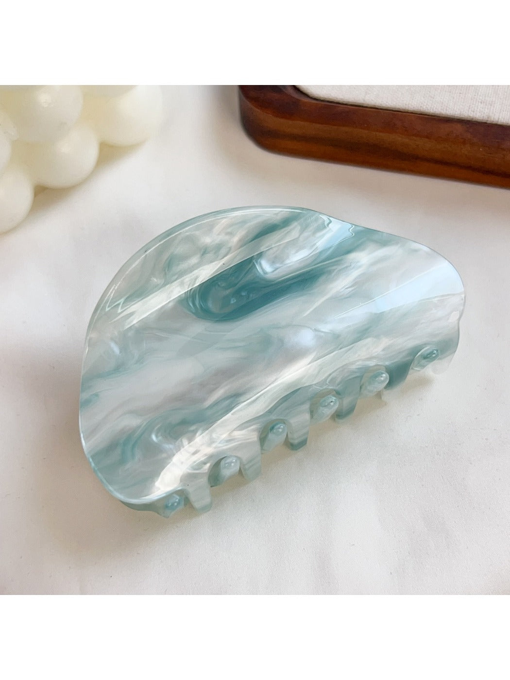 Beau hair claw clip displayed with soft lighting emphasizing translucent material