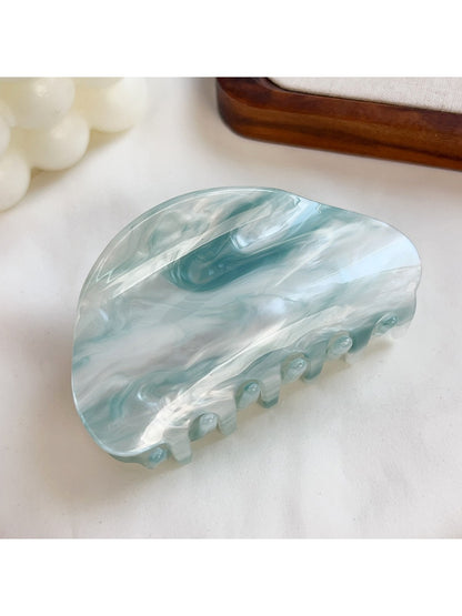 Beau hair claw clip displayed with soft lighting emphasizing translucent material