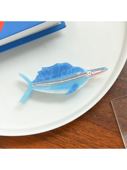 Beau tropical fish acetate hair clip placed on white background displaying vibrant colors