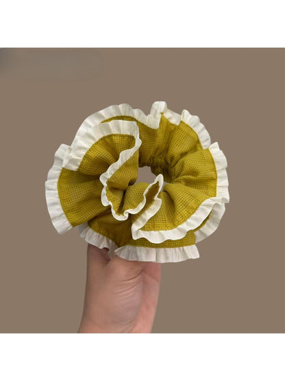 Green plaid scrunchie displayed flat highlighting pattern and trim