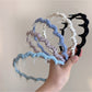 Side view of Gifty polka dot toothed comb headband showing teeth detail
