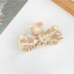 Beau bow shaped claw clip used in a casual ponytail hairstyle