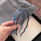 Minimalist denim wave headband displayed on a white background