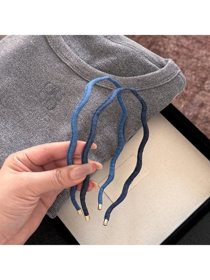 Minimalist denim wave headband displayed on a white background