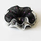 Gifty scrunchie with ruffled edges and classic white polka dots on fabric