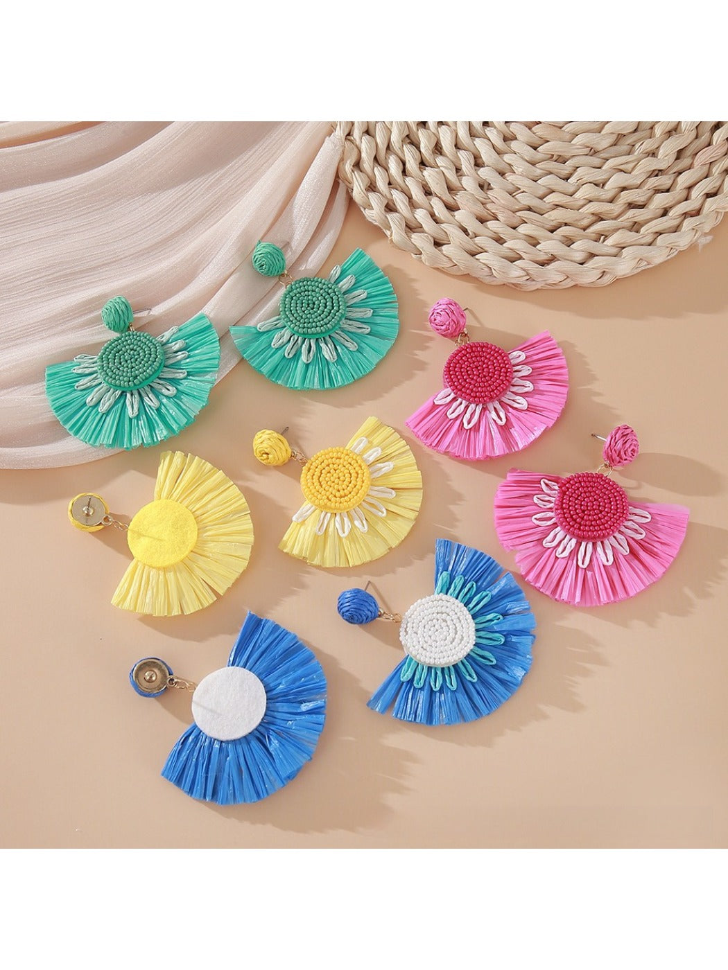 Earedge fan shaped drop earrings displayed on a jewelry stand