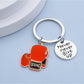 Side view of metallic boxing glove keychain showing its compact size