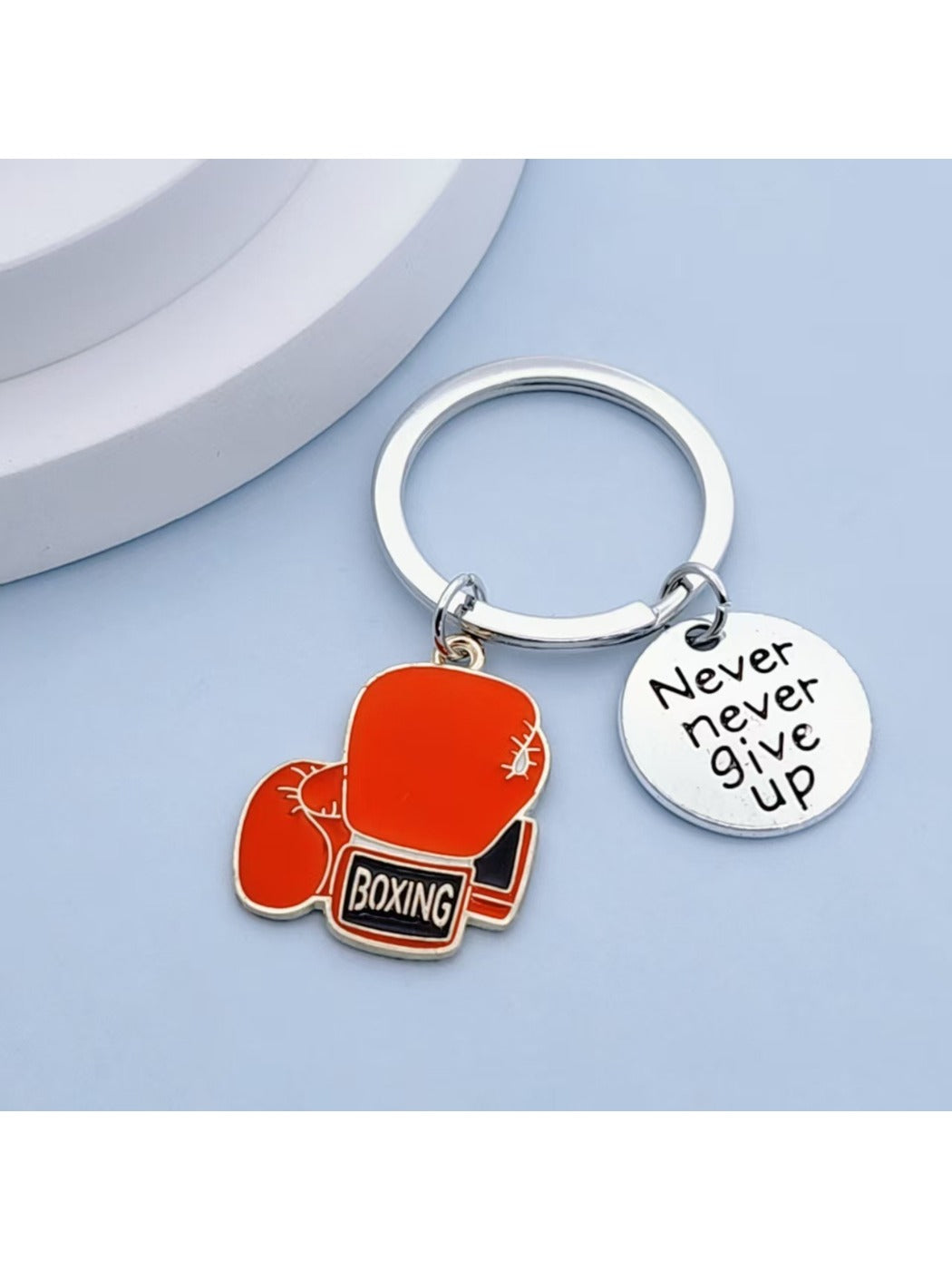 Side view of metallic boxing glove keychain showing its compact size