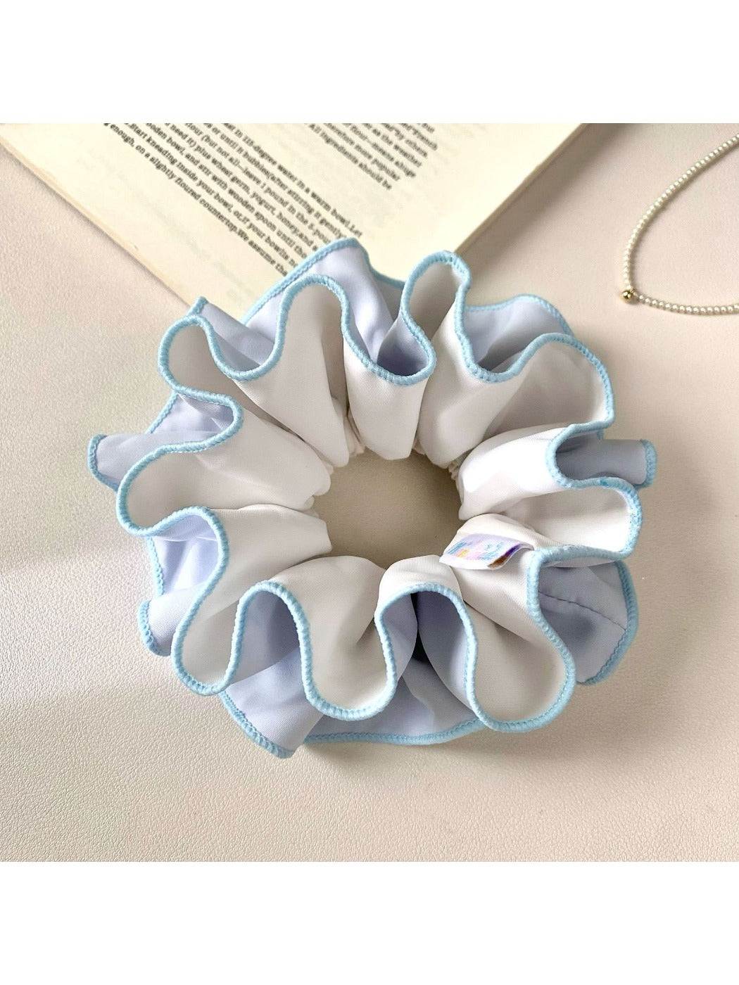 Top view of Gifty color block scrunchie displaying ruched fabric detail