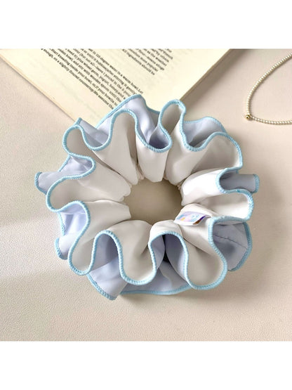 Top view of Gifty color block scrunchie displaying ruched fabric detail