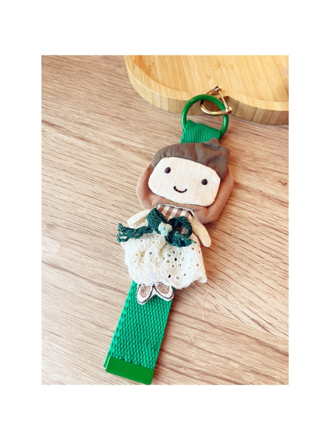 Side view of fabric patchwork woven strap keychain highlighting fabric layers and metal ring