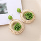 Detailed shot of the natural raffia fibers used in Earedge woven earrings