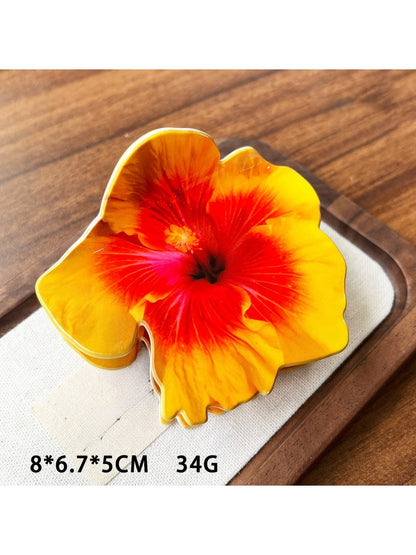 Beau hibiscus claw clip shown with matching floral accessories