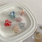 Beau sweet flower shaped small claw clip in pastel pink on white background