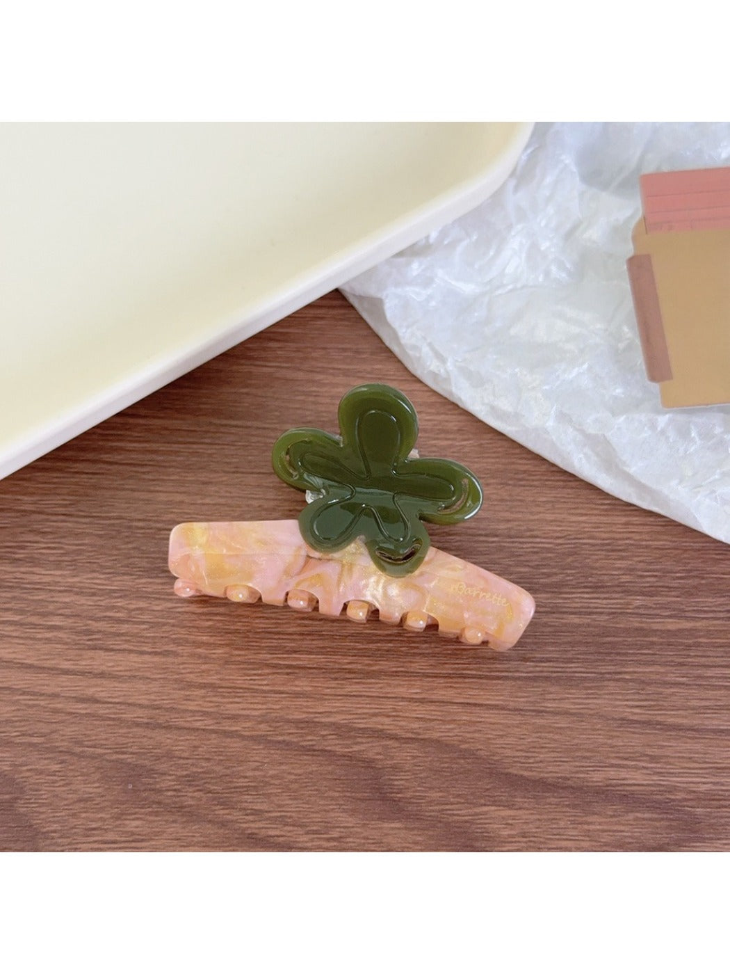 Beau claw clip photographed with soft shadows emphasizing color contrast