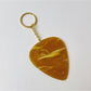 Hand holding the Keypus textured teardrop charm keychain against a blurred background